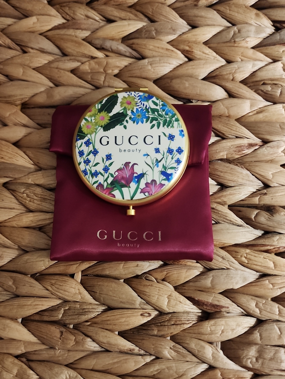 Gucci floral enamel compact mirror with gold trim and burgundy pouch